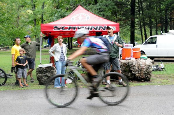 Sam Pearson of Bentonville, right, shouts encouragement to racers.