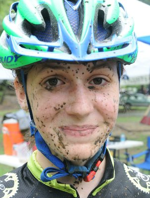 Emma Drummond, 14, of Springdale, wears some of the Fossil Flats Trail on her mud-splattered face after racing.
