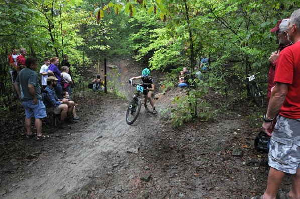 Race fans watch a rider walk up the Gravity Cavity after a spill.