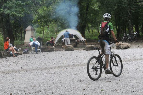 Park visitors watch a race from their campsite.