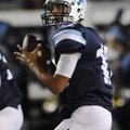 Kyle Pianalto, the Springdale Har-Ber quarterback, drops back to look for a open receiver Friday aga...
