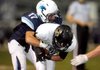 Hunter Patrick, Springdale Har-Ber senior cornerback, grabs Bentonville senior wide receiver Trey Perkins following a reception Friday at Jarrell Williams Stadium in Springdale.