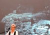 Ellen Compton, with a picture of her father, Dr. Neil Compton, projected behind her, talks Wednesday at the University of Arkansas at Fayetteville about her father’s efforts to preserve the Buffalo River. 
