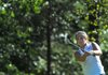 Katie Christian, 17, of Rogers Heritage chips the ball onto the green Tuesday at Prairie Creek County Club in Rogers.