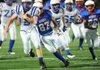Bradon Mabry, left, Rogers High freshman running back, carries the ball Thursday as George Junior High’s Jesus Perez pursues in the first half at Jarrell Williams Bulldog Stadium in Springdale.