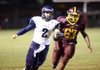 Little Rock Christian’s Houston Angel (2) runs past North Pulaski’s David Jackson (63) early in the first quarter of the Warriors’ 46-12 victory over the Falcons on Friday. 
