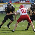 Nick Sugg, Prarie Grove junior, looks for a hole in the Farmington defense during the first quarter ...