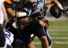 Tucker Lee, Springdale Har-Ber, plows Friday through Rogers Heritage’s defensive line at Gates Stadium in Rogers.