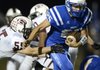 Ty Galyean, right, Rogers running back, sheds Springdale defensive back Caylon Wells on an 80-yard carry during the second quarter of the Mounties’ game Sept. 21 the Bulldogs at Mountie Stadium in Rogers.