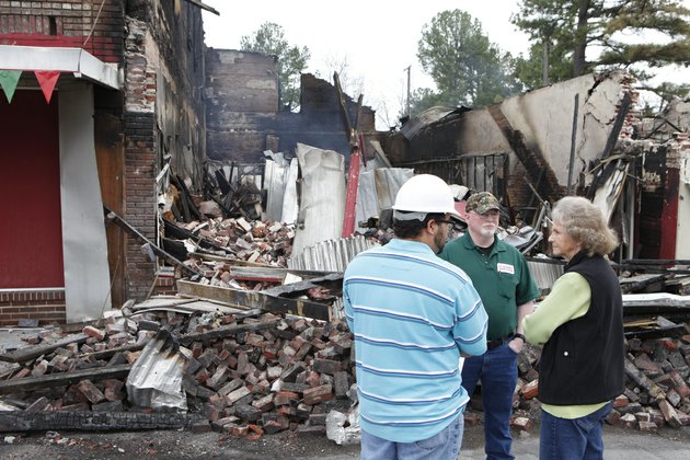 from-the-left-jason-gilkey-with-the-arkansas-department-of-environmental-quality-steve-brown-superintendent-of-kensett-water-and-sewer-and-esetelene-sebourn-who-owns-one-of-the-burned-buildings-talk-about-the-process-for-removing-debris-left-after-a-fire-destroyed-several-buildings-in-downtown-kensett