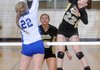 MacKenzie Muirhead, left, of Rogers High tries to block a kill by Bentonville's Anna LeDuc on Tuesday in Tiger Arena at Bentonville