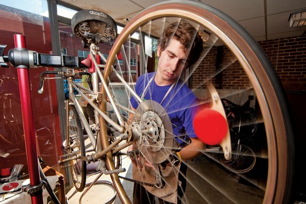 hendrix-senior-adam-grippo-works-on-a-bike-at-the-student-run-bike-shop-on-campus-grippo-began-repairing-his-own-bikes-in-high-school-to-save-money