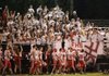 Farmington students in the “Birdcage” section of the away-team bleachers at Prairie Grove cheer on their team during a Sept. 28 game.