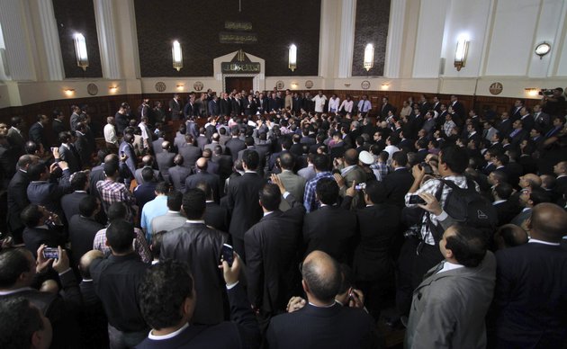 egyptian-prosecutor-general-abdel-meguid-mahmoud-speaks-to-hundreds-of-supporters-judges-lawyers-and-media-in-a-downtown-courthouse-defying-a-presidential-decision-to-remove-him-from-his-post-saying-this-infringes-on-the-judiciarys-independence-in-cairo-egypt-saturday-october-13-2012-president-mohammed-morsi-ordered-prosecutor-general-abdel-meguid-mahmoud-to-step-down-to-appease-public-anger-over-the-acquittals-of-ex-regime-officials-accused-of-orchestrating-violence-against-protesters-last-year
