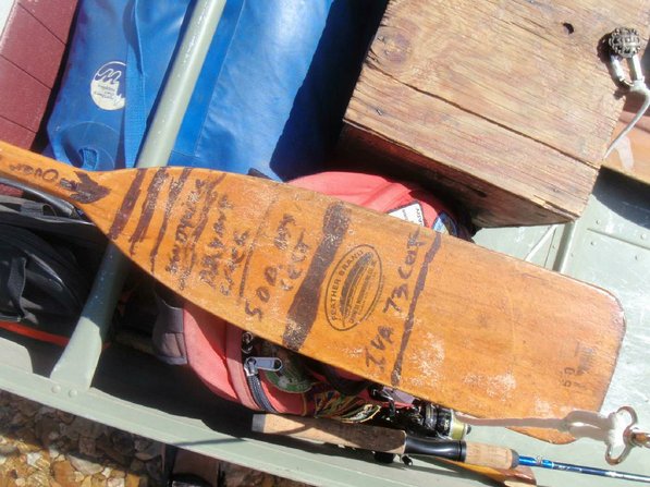 Matt Hughes keeps track of his river trips with notes written in marker on his paddle.