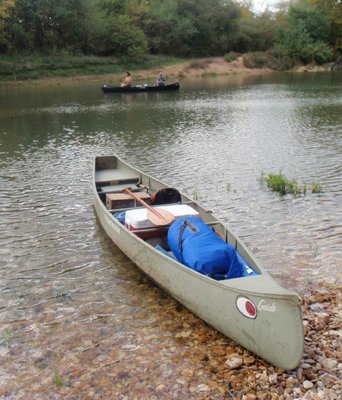 Canoes transported people and camping gear down the Kings River. Matt Hughes, left, and his brother, Mark "Hog Ears" Hughes fish the river on Sunday during a two-day float.