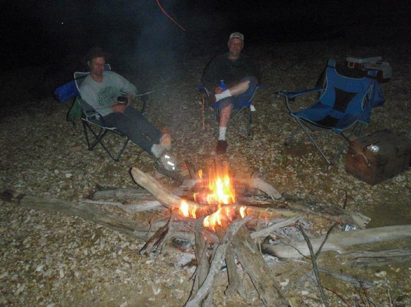 Matt Hughes, left, and his brother, Mark "Hog Ears" Hughes, enjoy the night's campfire.