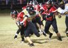 Dayton Win of Pea Ridge is tackled Friday by Prairie Grove’s Christian Gamez at Blackhawk Stadium in Pea Ridge.