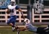 Ty Galyean, left, of Rogers tries to outrun Jerry Wood of Springdale Har-Ber High School on Friday at Jarrell Williams Bulldog Stadium in Springdale