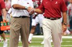 Arkansas Coach John L. Smith (left) meets with Alabama Coach Nick Saban on Sept. 15 in Fayetteville. Smith leads the Razorbacks against Mississippi on Saturday in Little Rock.