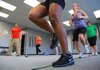 Jessica Olsen (second from right) laughs at a comment from instructor Jeff McDaniel (left) during an intense circuit training group exercise called Tabata offered at FastFit Training Center in Little Rock. 