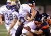 Brandon White, right, Rogers Heritage junior linebacker, pulls down Daltan Lovell, Harrison senior quarterback, during the first half Sept. 14 at Gates Stadium in Rogers. White and teammate Colby Isbell were named NWA Media Players of the Week.
