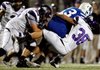 Reese Fitchue, left, Fayetteville senior defensive lineman, brings down Mick Wary, Rogers High senior quarterback, during the first half Oct. 12 at Mountie Stadium in Rogers. Fitchue moved from defensive end to tackle prior to his senior year.