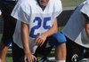 Rogers’ Ty Galyean talks with teammates during practice Aug. 7. Galyean will get his first start at quarterback Friday night.
