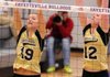 Haley Seyfarth, left, Bentonville sophomore, reaches to block a shot against Fayetteville on Oct. 16 at Bulldog Gym in Fayetteville. Seyfarth was named the Tigers’ starting setter at the beginning of the season.