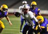 Little Rock Parkview running back Rashad Earls (middle) is tackled by Little Rock Catholic defender Barth Onyewkelu (lower right) during the first half of the Patriots’ 15-13 loss to the Rockets on Thursday at War Memorial Stadium in Little Rock. 