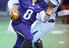 Austin Allen, Fayetteville senior quarterback, scrambles with the ball through the Springdale Har-Ber defense Friday during the first half at Harmon Stadium in Fayetteville. 