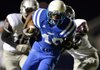 Bryan Grigsby, Rogers High running back, breaks an attempted tackle by Siloam Springs safety Tyler Burke on his way to a second quarter touchdown Friday at Mountie Stadium in Rogers. 