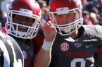 Quarterback Tyler Wilson (right), celebrating a fourth-quarter touchdown with Javontee Herndon, had a few happy moments during Saturday’s game but also had some bad moments. He tied a careerhigh for interceptions and missed some potentially big throws.