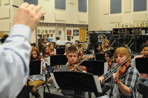 
                           The orchestra follows the conductor's hand. BHS orchestra director Jesse Collett conducts the orchestra.