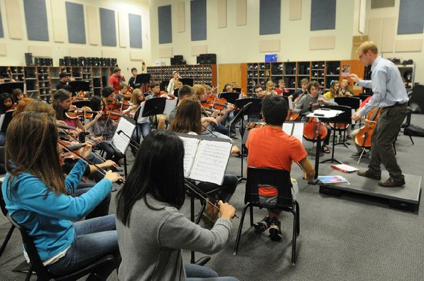 
                           Jesse Collett, orchestra director, conducts a practice at Bentonville High School.