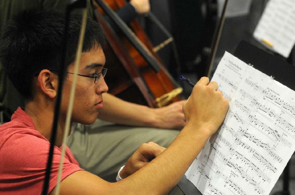 
                           Thor O'Connor makes notes on his sheet music. 