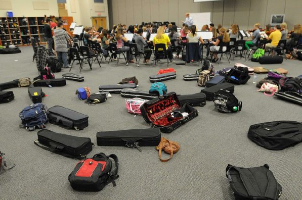 
                           Instrument cases and book packs are standard equipment for orchestra members.