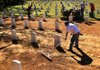 David Furnish (front) and other workers make improvements Tuesday to the state Veterans Cemetery in North Little Rock, which is receiving a $1.1 million grant this week. 