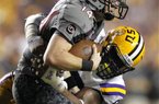 LSU defensive end Sam Montgomery sacks South Carolina quarterback Connor Shaw (14) during the second half of an NCAA college football game in Baton Rouge, La., Saturday, Oct. 13, 2012. LSU won 23-21. (AP Photo/Gerald Herbert)