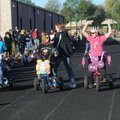 Alicia Billis, right, cheers to get her teacher tricycle-racing team ready to ride Wednesday at Tenn...