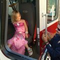 Katherine Bailey, 4, from Fayetteville, gets a little help Wednesday from Fayetteville firefighter M...