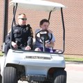 Michael Elkins, school resource officer, watches as eighth-grader Chuck Ellison tries his hand Wedne...