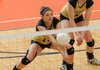 Hailey McNee, left, of Bentonville digs a ball hit by North Little Rock on Wednesday as Sabrina Shepherd watches during the quarterfinals of the 7A State Volleyball tournament at Rogers Heritage. 
