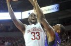 NWA Media/ MICHAEL WOODS --11/02/2012 -- University of Arkansas forward Marshawn Powell goes up for a lay up over Southwest Baptist defender Jaywuan Hill as he drives to the hoop in the first half of Friday night's game at Bud Walton Arena in Fayetteville.