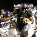 STAFF PHOTO JASON IVESTER -- Bentonville senior running back Tearris Wallace breaks through the Faye...