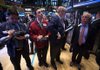 Traders work Friday at the New York Stock Exchange. Many stocks fell on the heels of Sandy. 