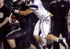Alex Brignoni, a Fayetteville senior defensive back, brings down Bentonville senior running back Garrett Kaufman during the second half on Friday at Tiger Stadium in Bentonville. 
