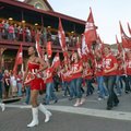 Members of the University of Arkansas Marching Band lead the homecoming parade Friday up Dickson Str...