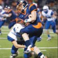 Micca Brown, right, Rogers Heritage, is tackled Friday by Rogers High’s Zack Wary.