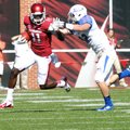 Arkansas receiver Cobi Hamilton (11) tries to fend off Tulsa defender Mitchell Osborne as he runs fo...